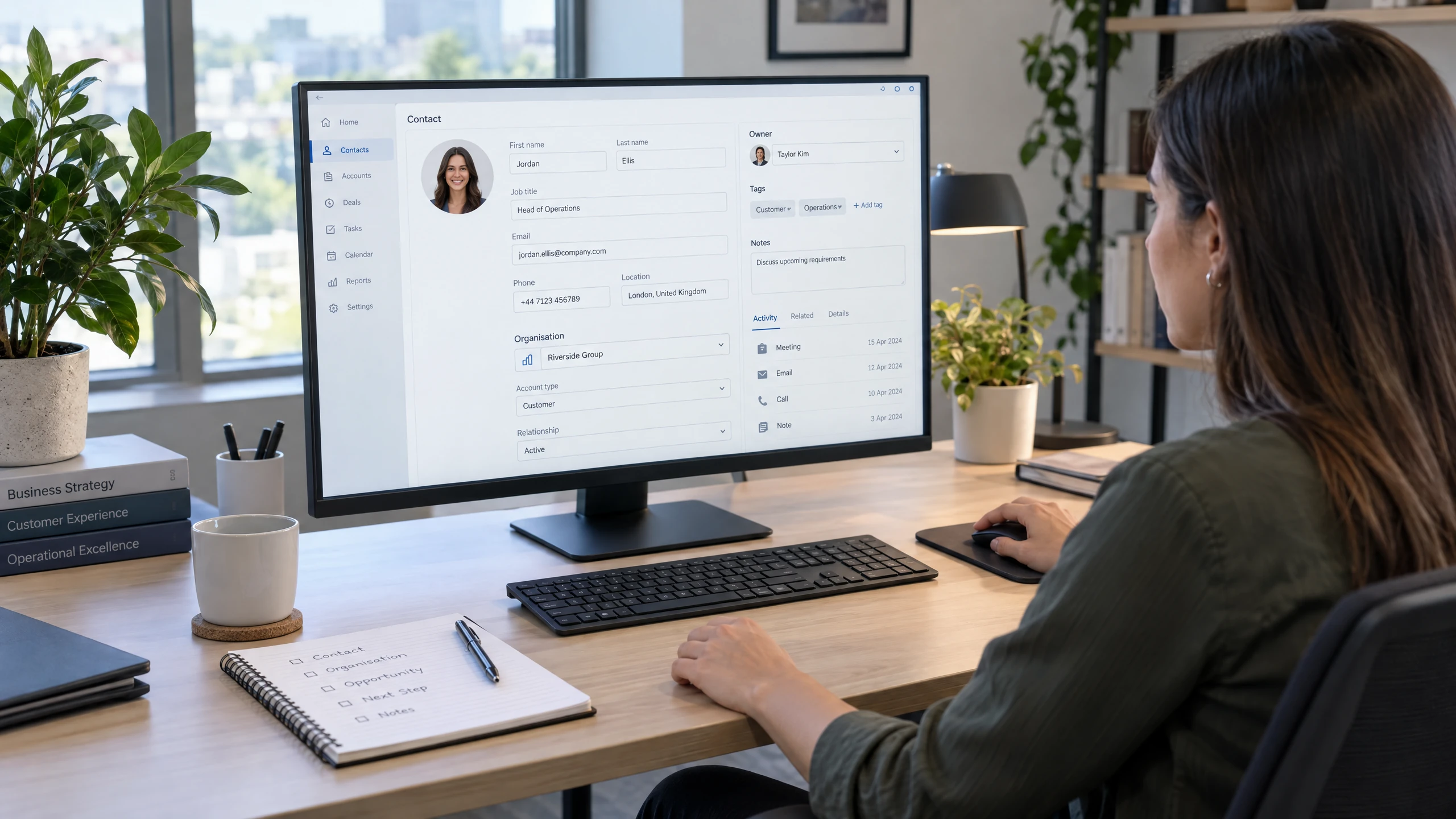 CRM administrator organising linked person and organisation fields on an unbranded contact record interface (illustrative)
