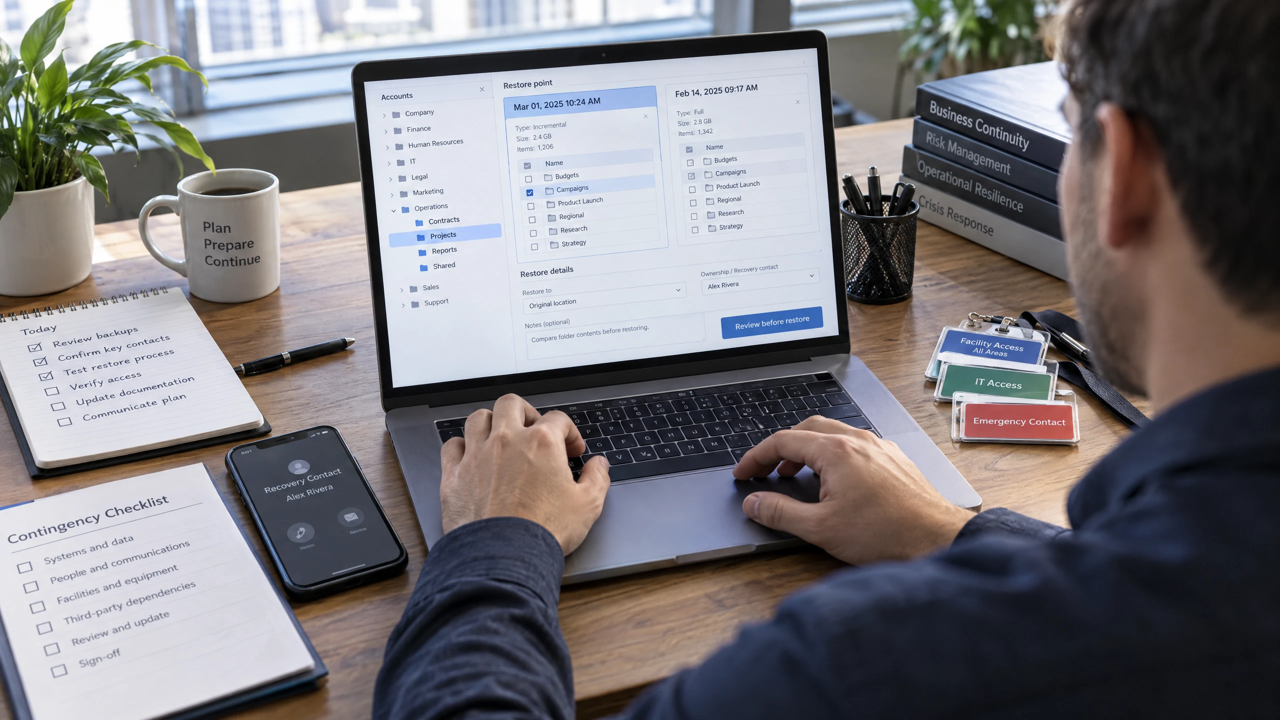 Operations lead selecting accounts, folders, and restore points while reviewing recovery contacts on a laptop (illustrative)